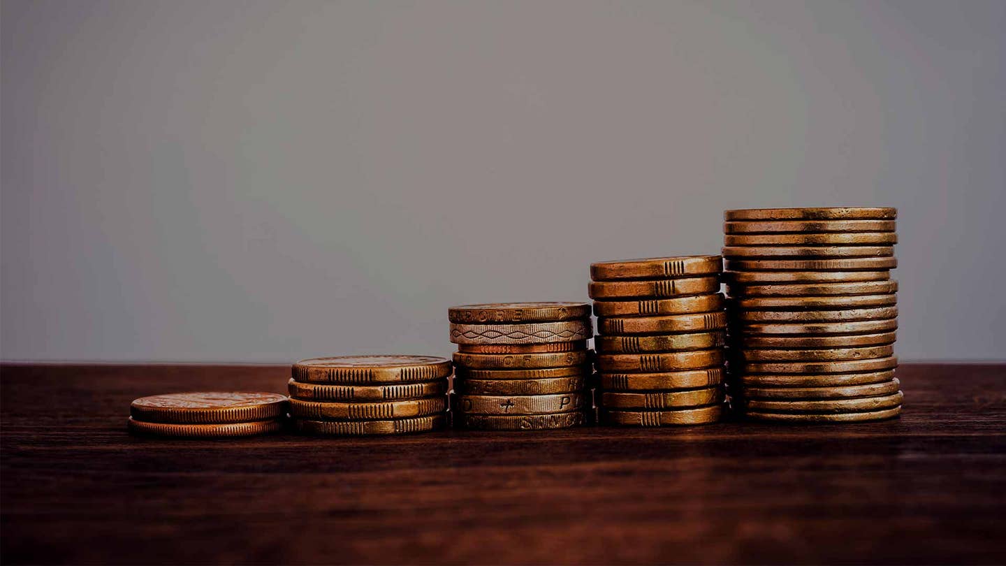 raise-gold-coin-stacks-worldwide-currency