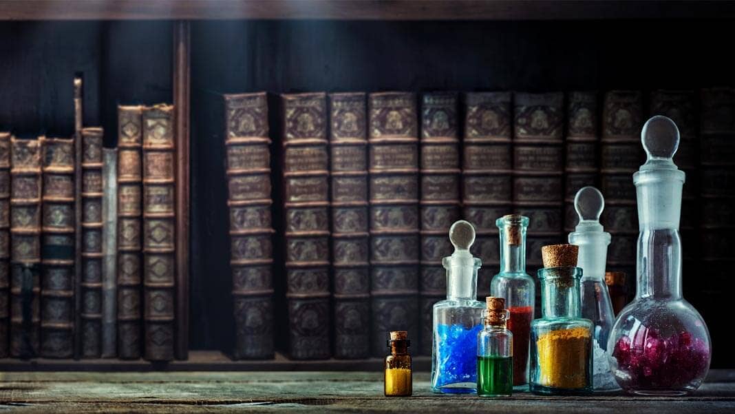 Longevity vintage medications in small bottles on wood desk and old book background