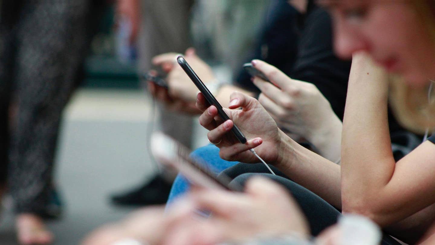 line of hands with phones Tech