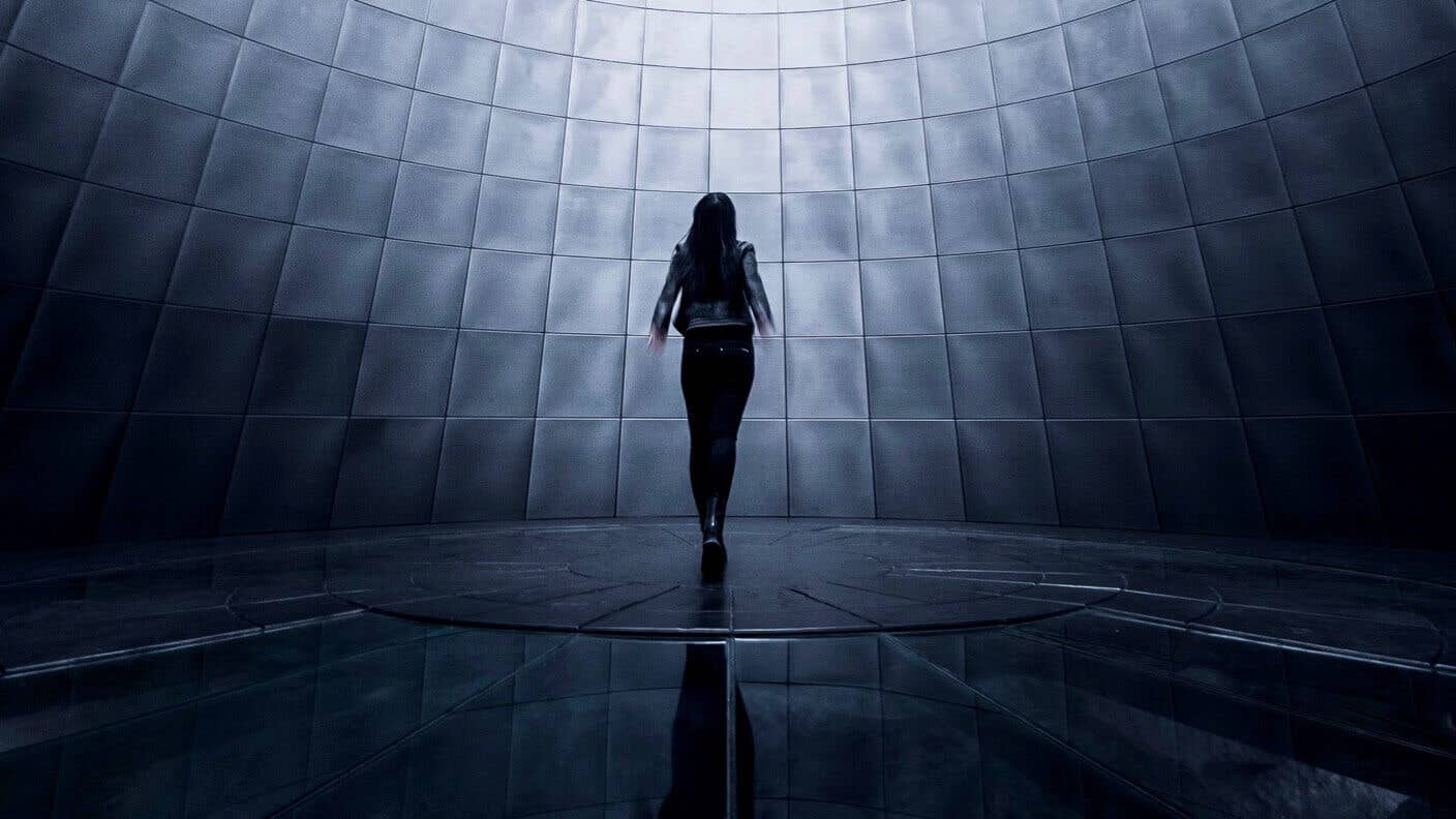 tech stories woman looking up tiled room grey white