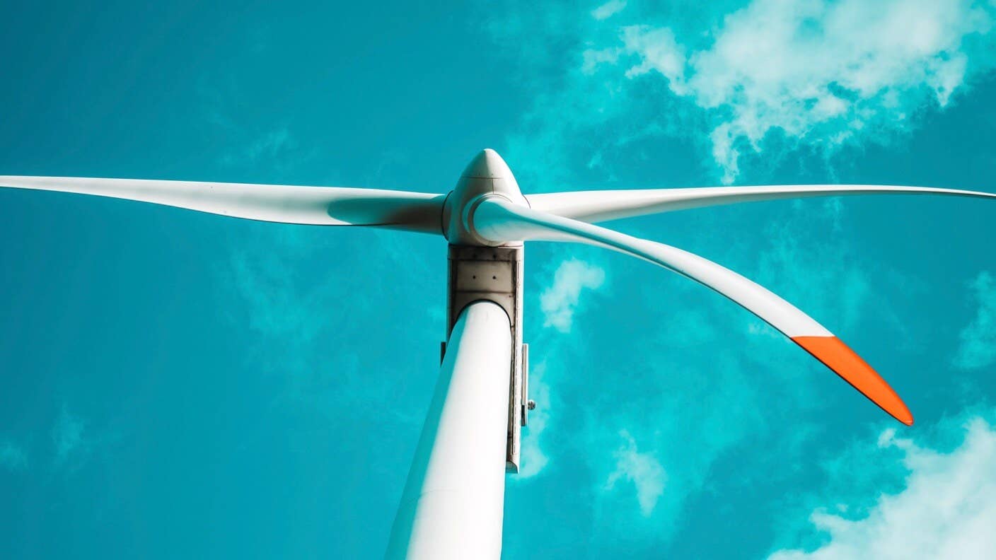 wind turbine red tipped rotors blue sky clouds