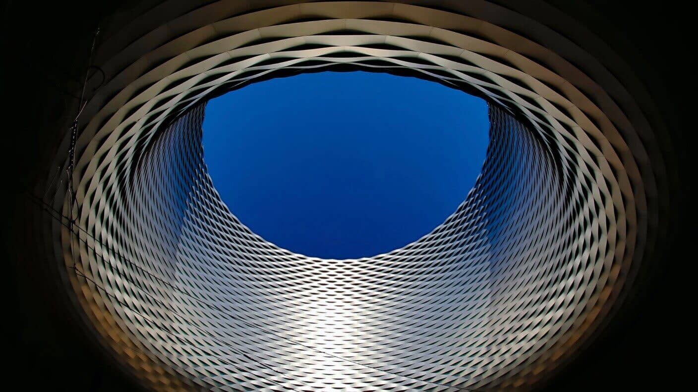 tech stories round silver architecture blue sky black background