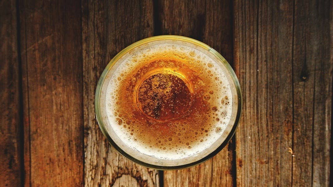 glass of beer on wood table machine learning synthetic biology hoppy beer