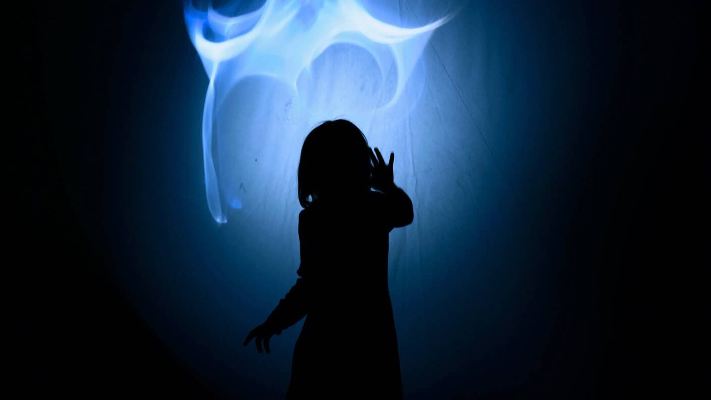 tech stories blue glowing light person sillhouette dark background