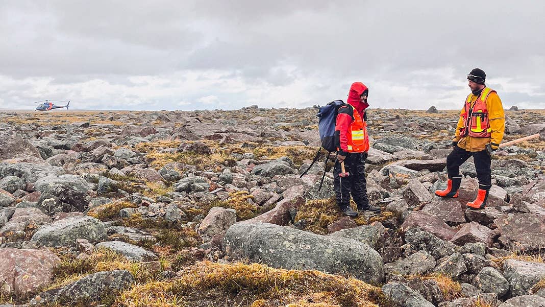 two men standing in a field of rocks KoBold Metals critical minerals mining