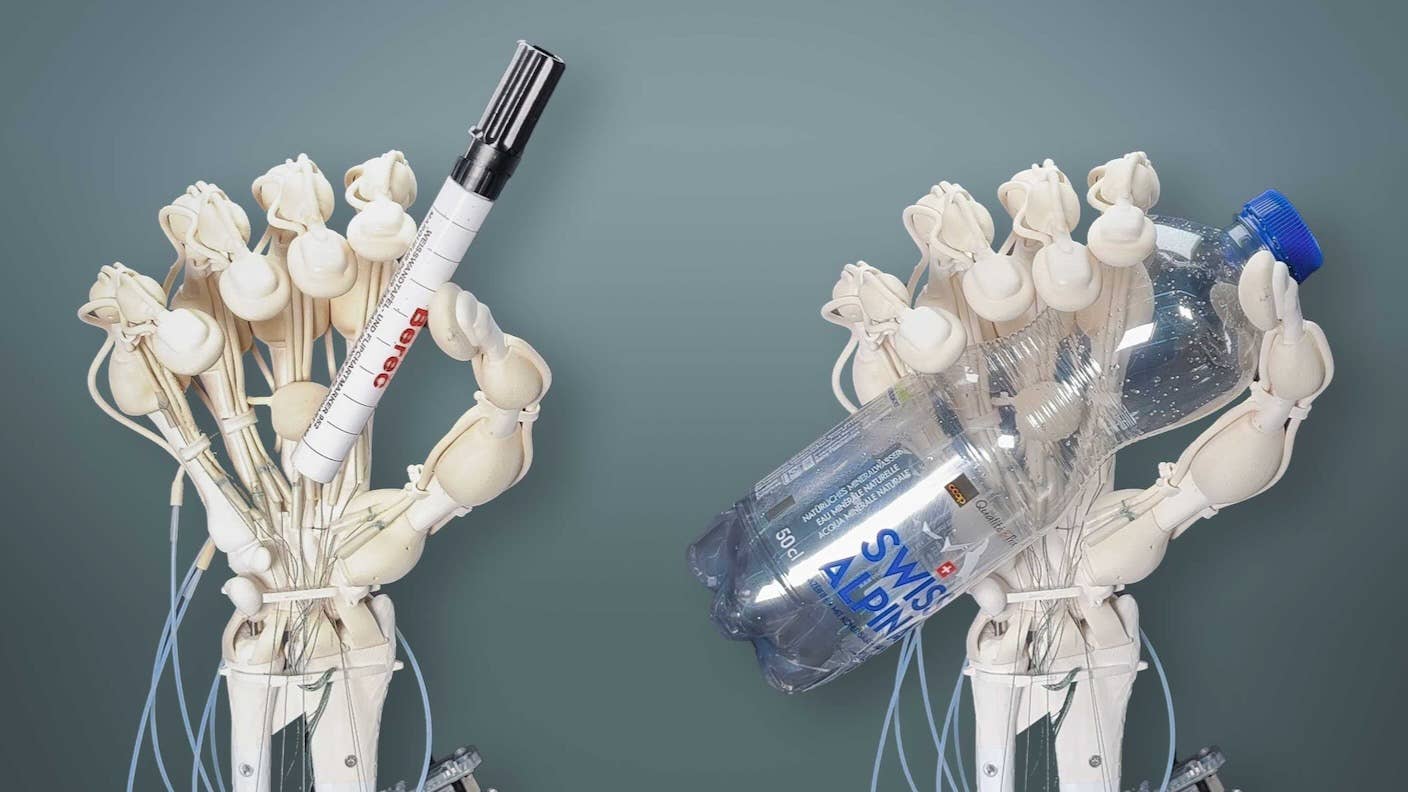 robotic hand grasping objects like a pen and plastic bottle