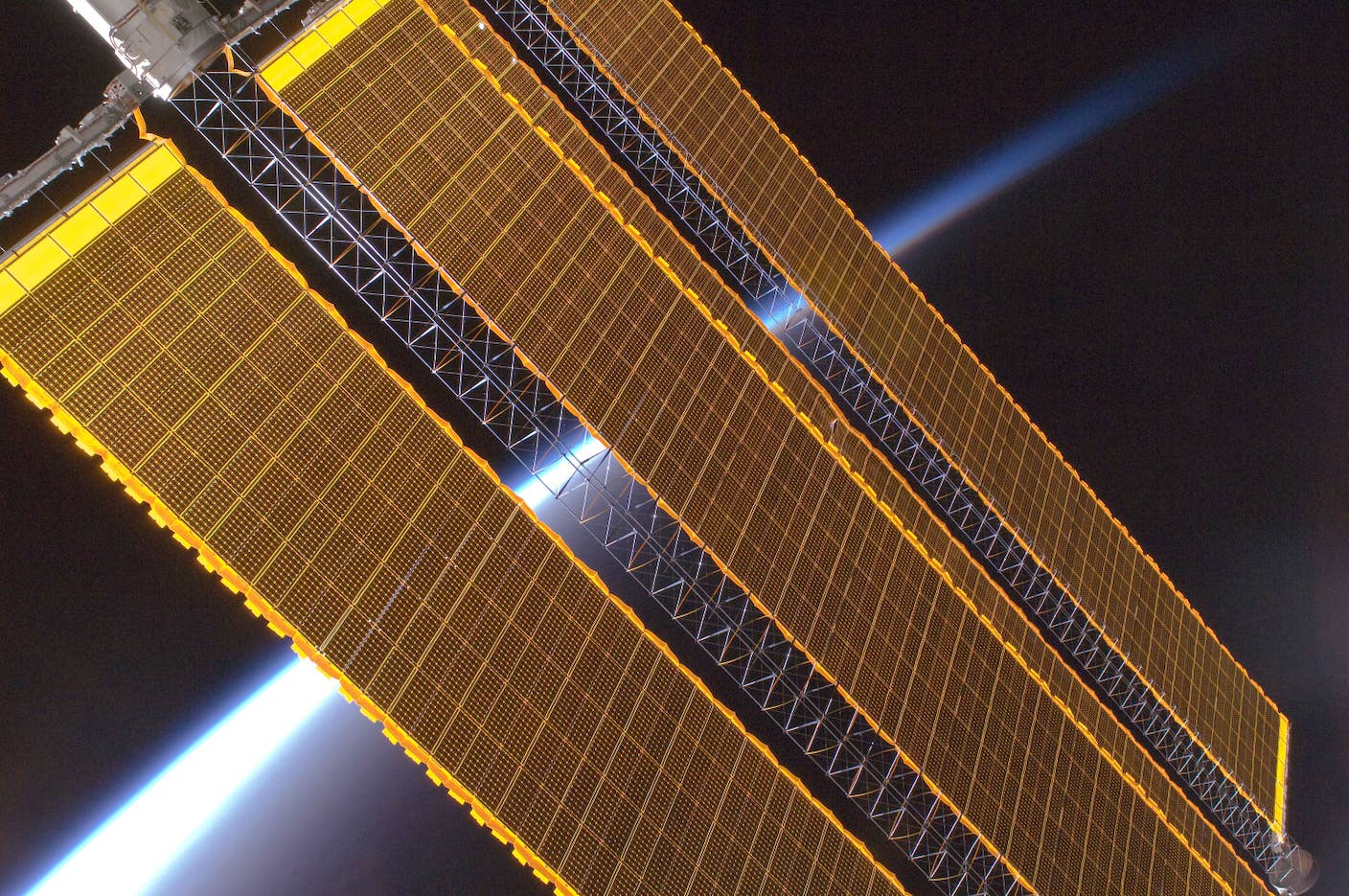 Solar panels on the ISS with Earth's horizon from space in the background