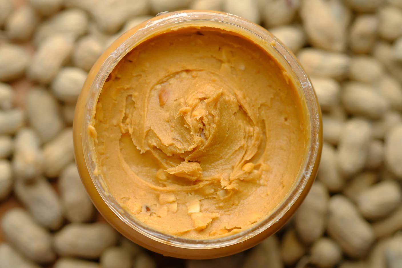 Scientists Just Developed a Lasting Vaccine to Prevent Deadly Allergic Reactions A full jar of peanut butter as viewed from the top