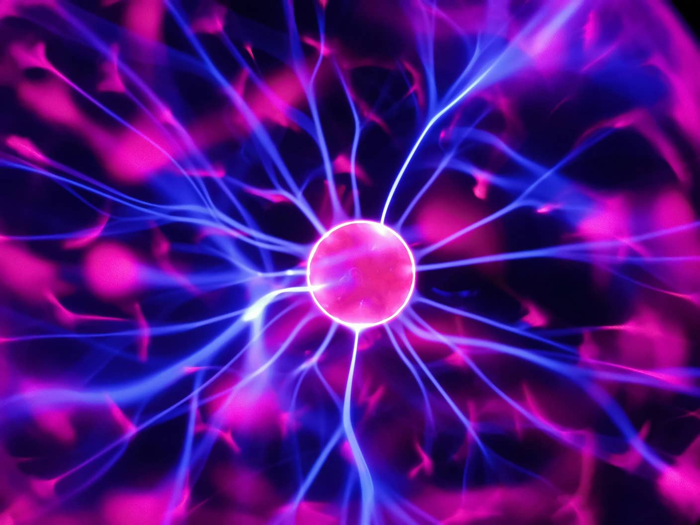 Strands of purple electricity feed central glowing pink sphere