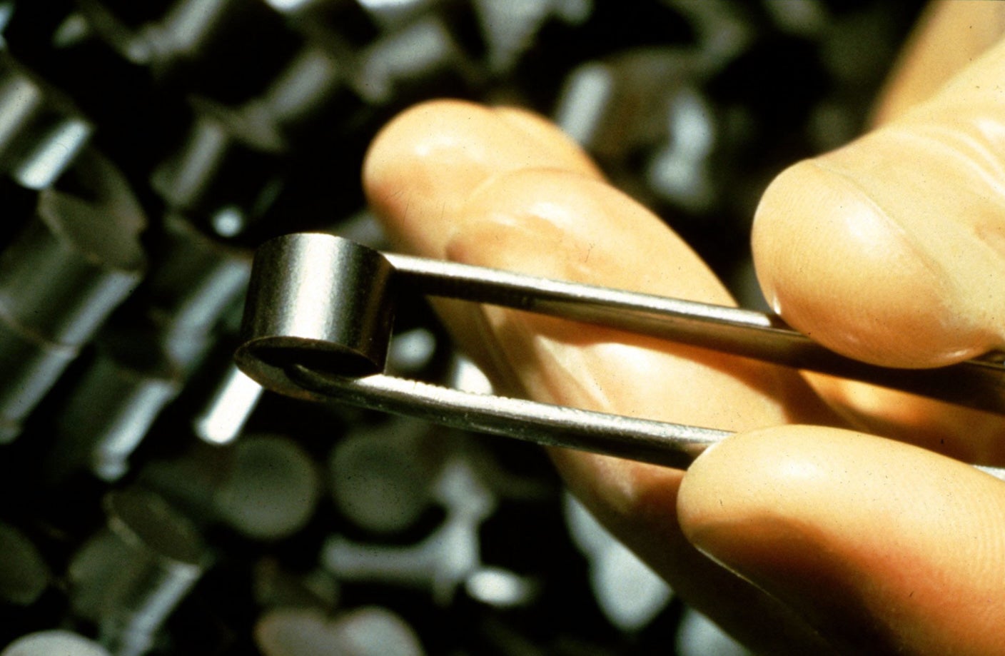 A nuclear fuel pellet held by tweezers