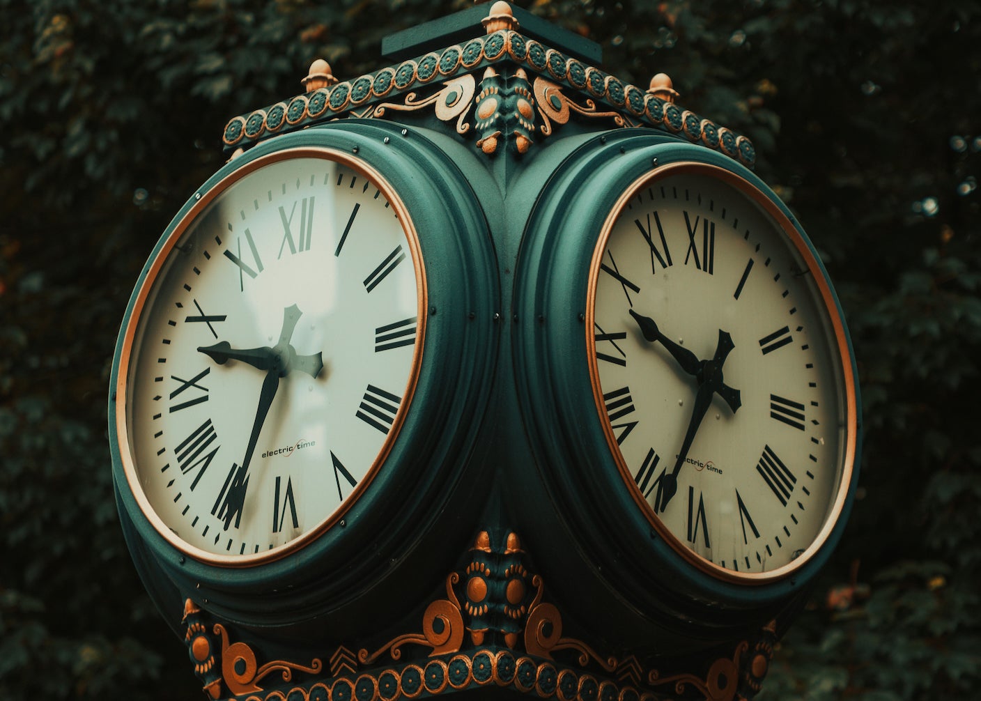 Two clocks with ornate green and gold styling