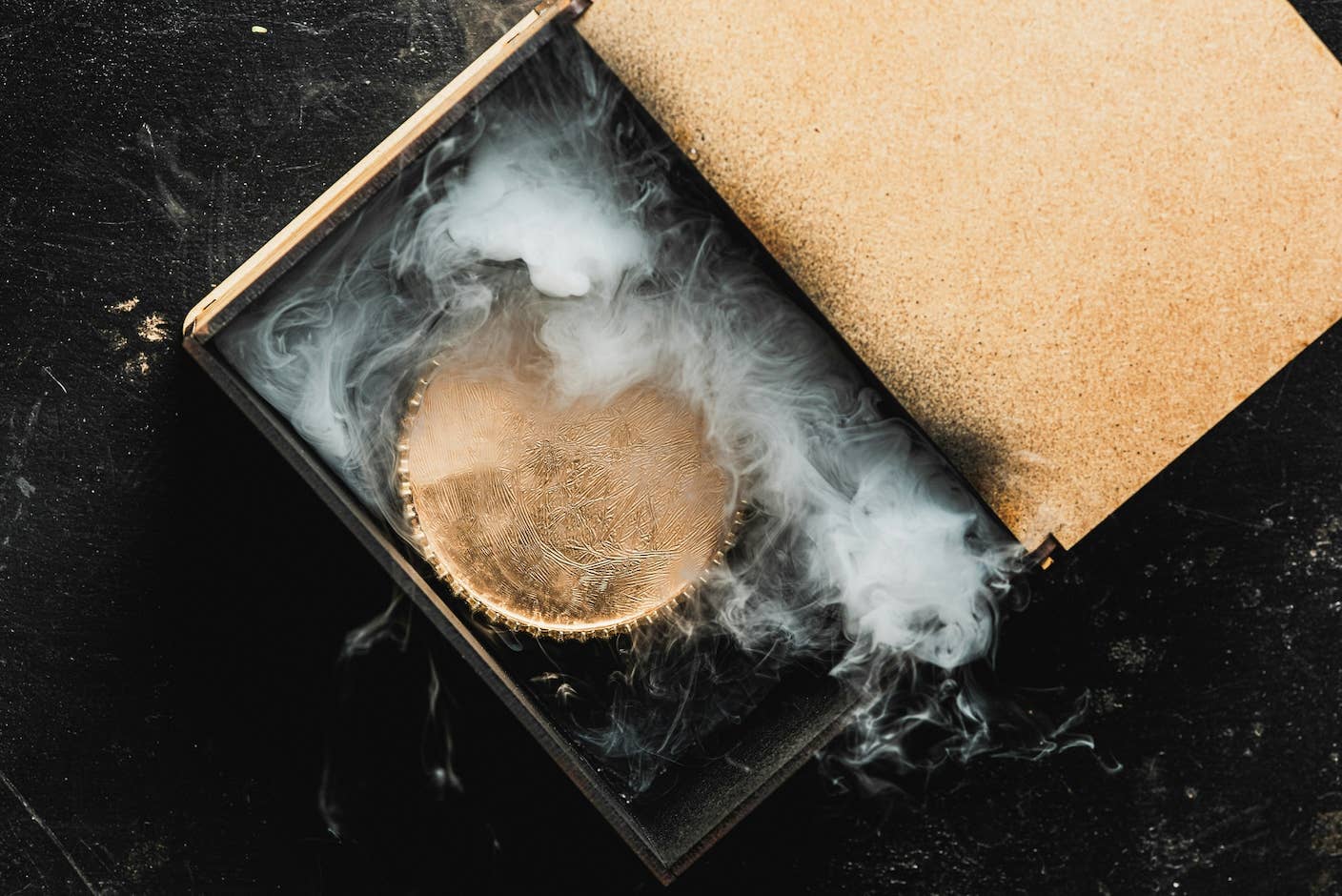 Researchers Break Open AI’s Black Box—and Use What They Find to Control It A box is opening with a smoking gold circular-object inside.