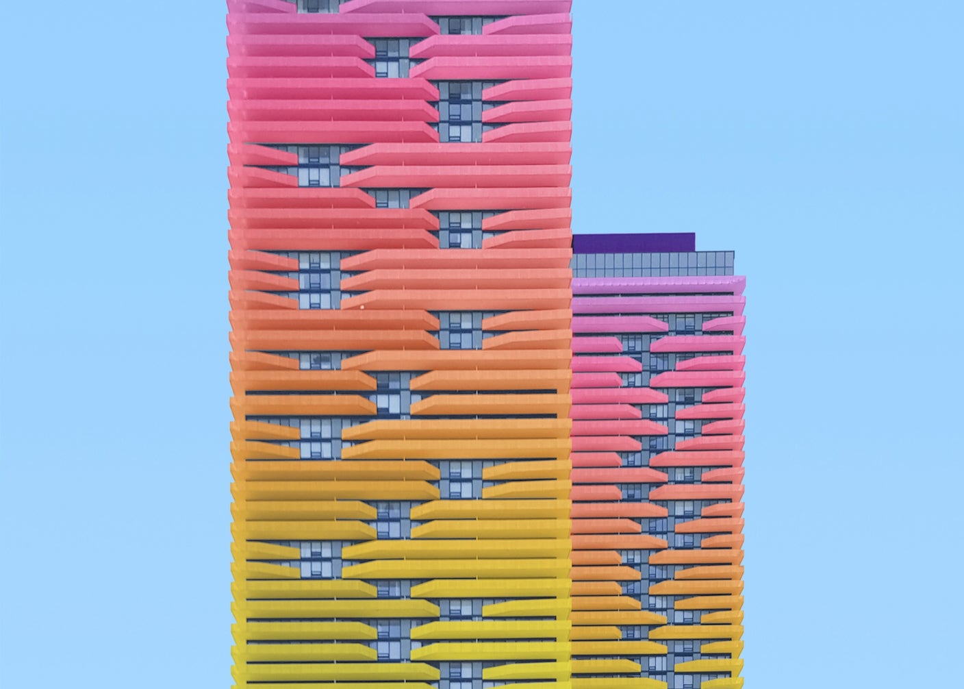 Two colorful high-rise buildings side by side.