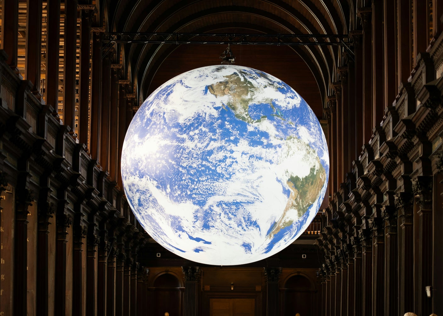 The Earth hanging inside a classical building