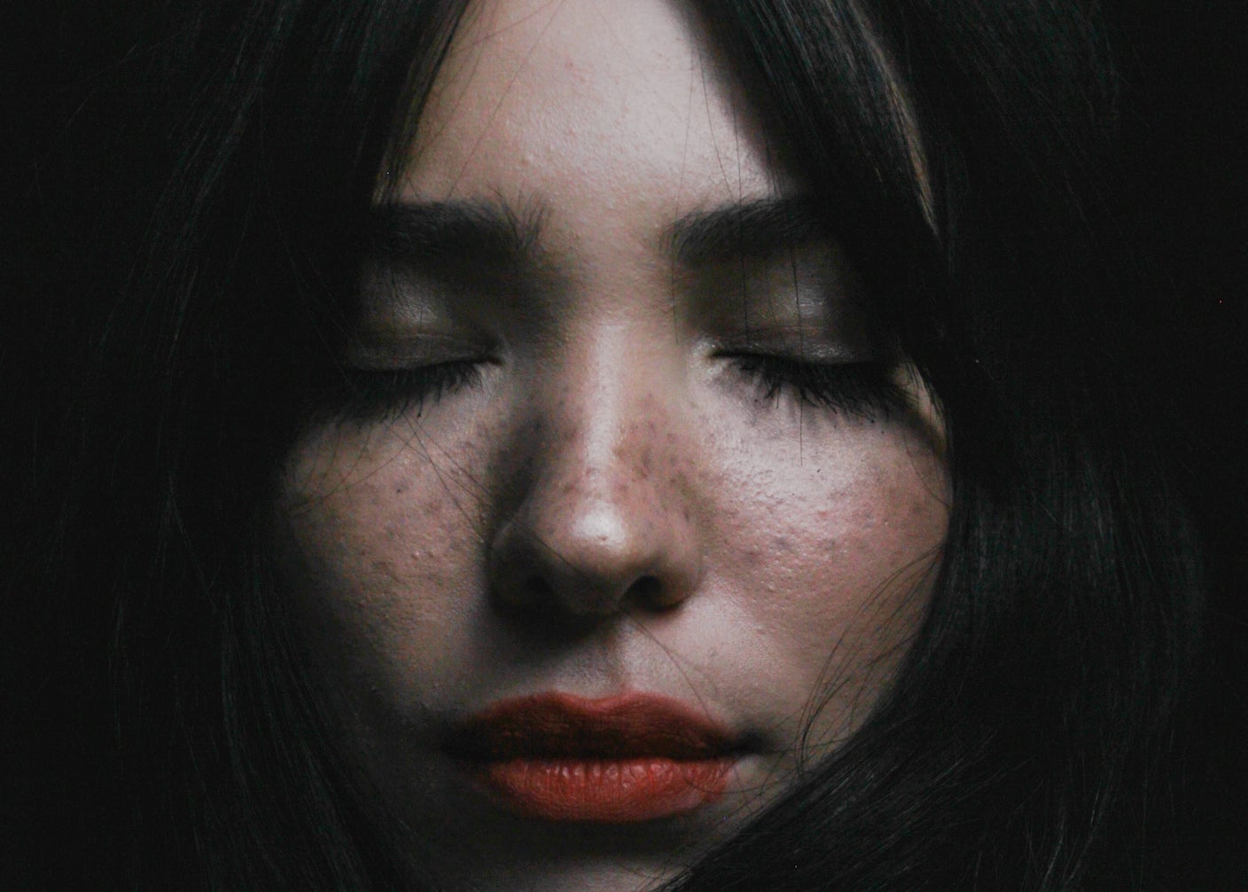 A woman with her eyes closed