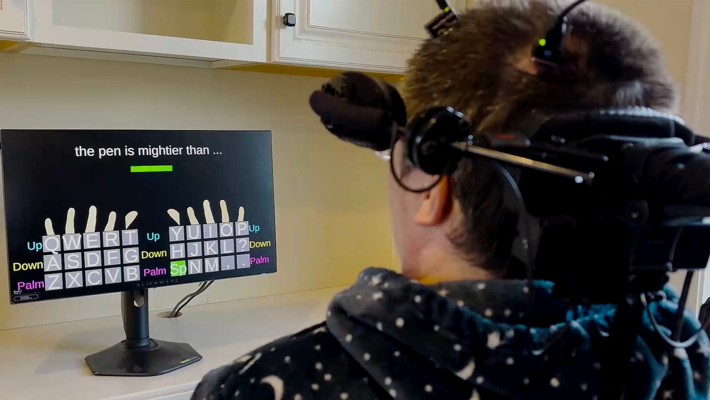 Man uses a brain-computer interface to type on a keyboard