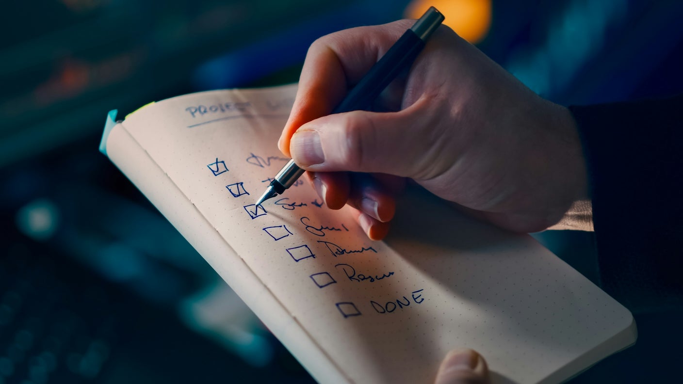 Person checking off boxes on a to-do list