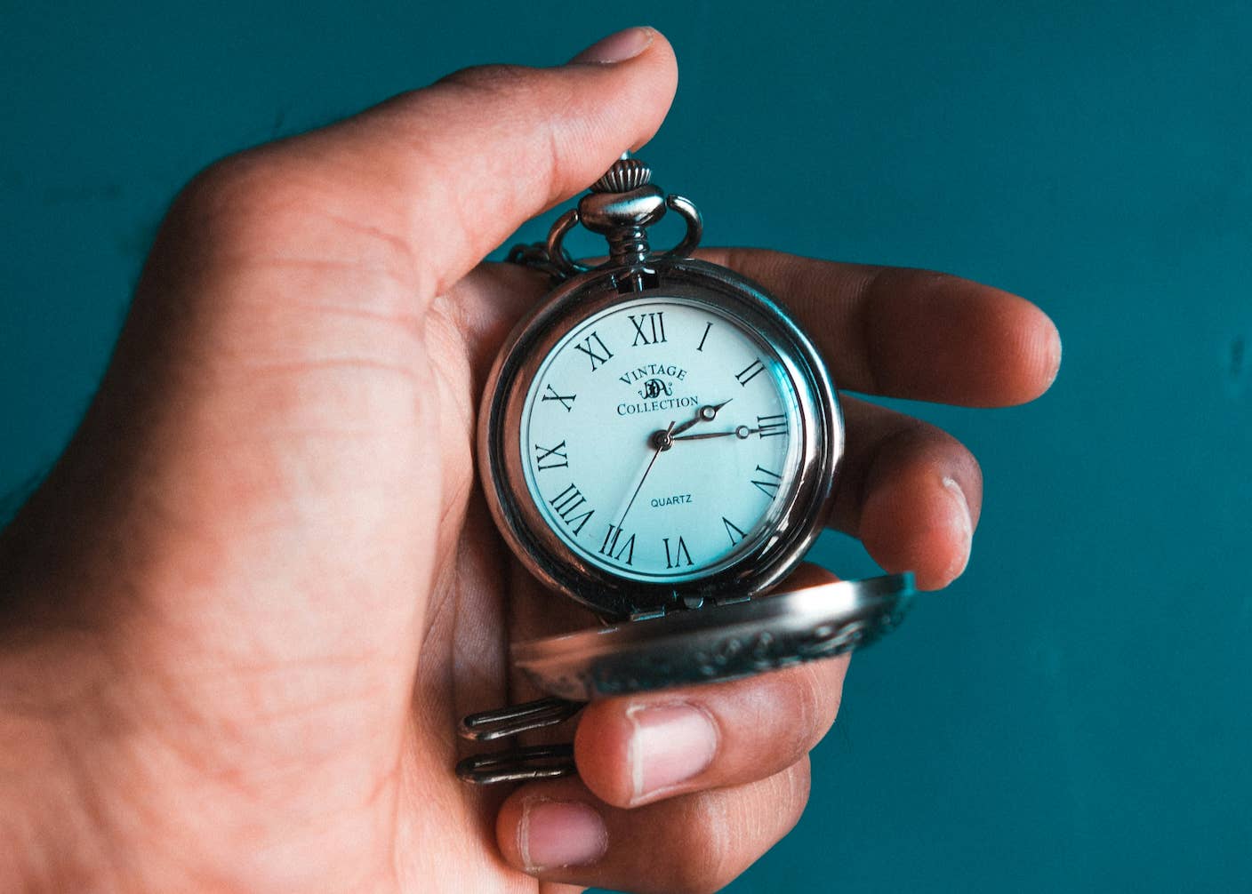 How Fast Are You Aging? New Genetic Clock May Have the Answer A hand holding an analog watch