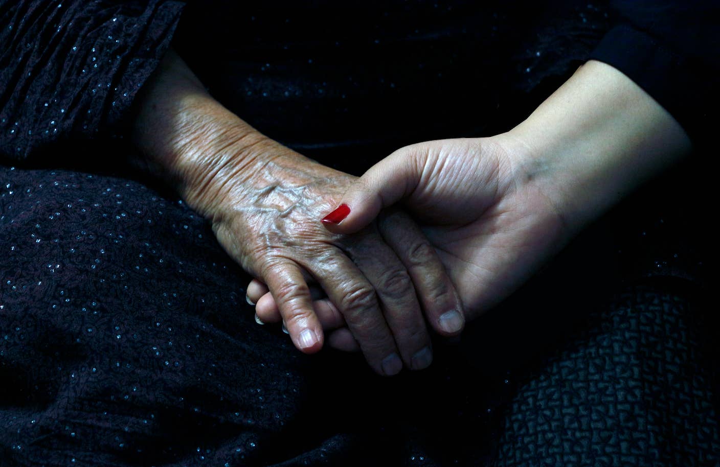 Designer Enzyme Strips Decades of ‘Rust’ From Aging Human Tissue Two people, one older and one younger, hold hands