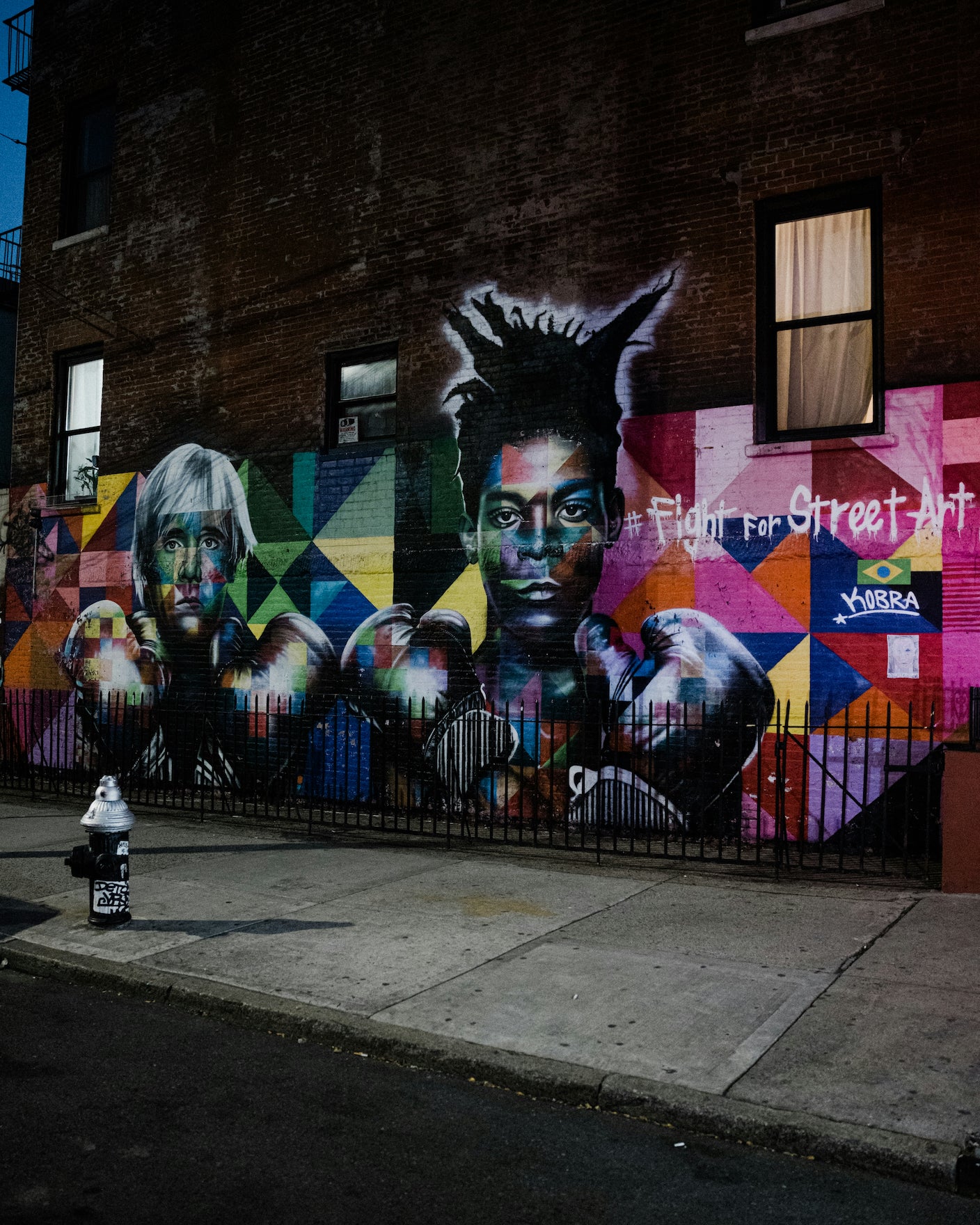 A Kobra street mural in NYC of Andy Warhol and Jean-Michel Basquiat with boxing gloves