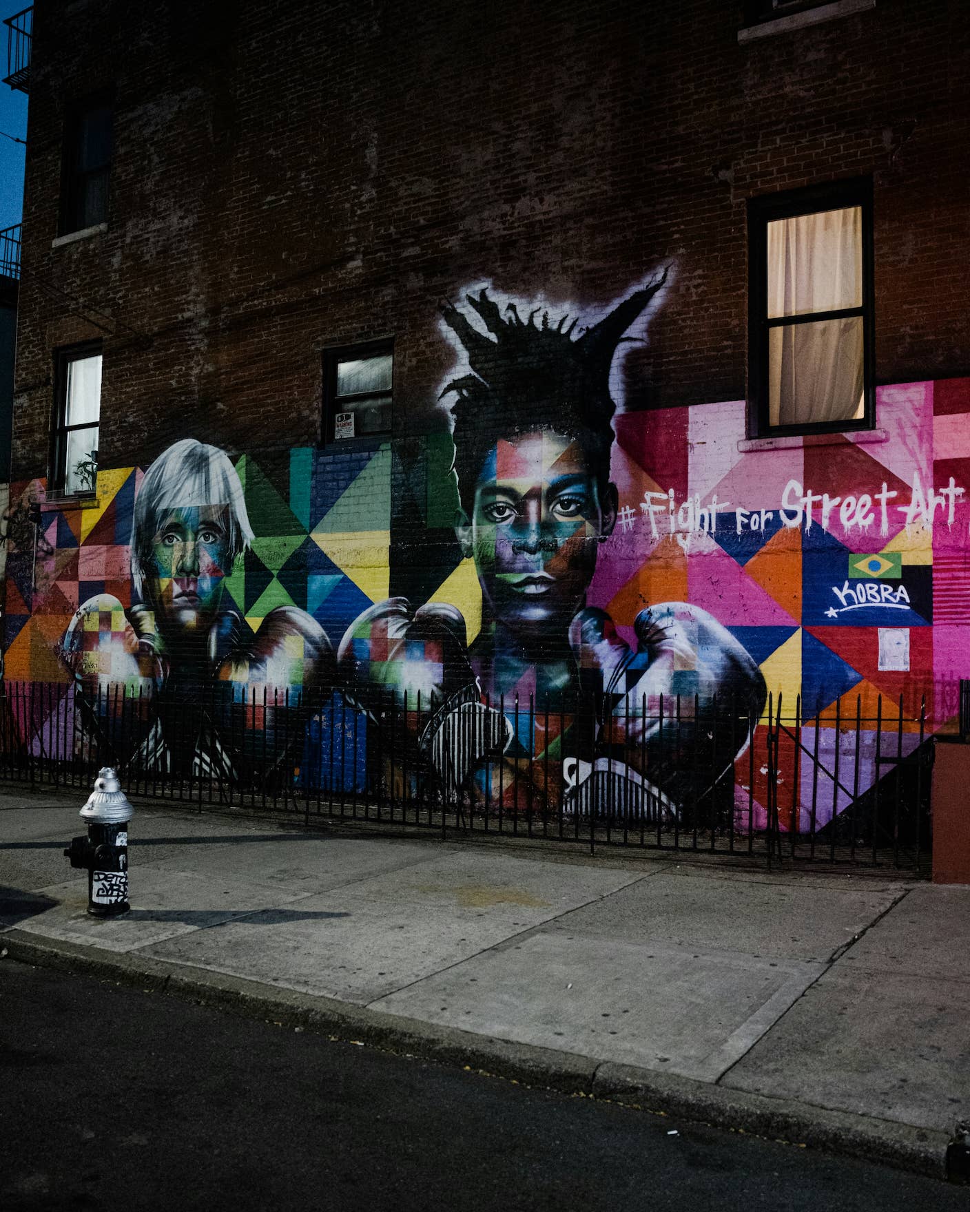 A Kobra street mural in NYC of Andy Warhol and Jean-Michel Basquiat with boxing gloves