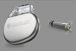 Medronic mini Micra pacemaker next to a more traditional pacemaker.
