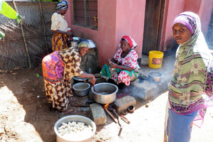 Women_cooking_using_the_open_fire_stove