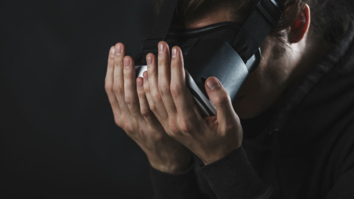 man-staring-at-hands-virtual-reality-vr