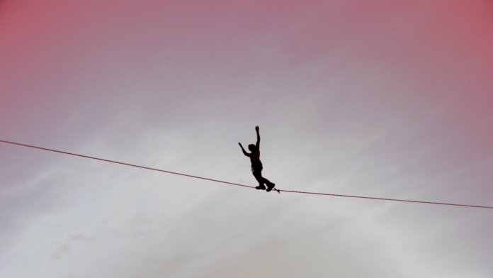 unsafe-thinking-walking-tightrope-slackline-sky-view
