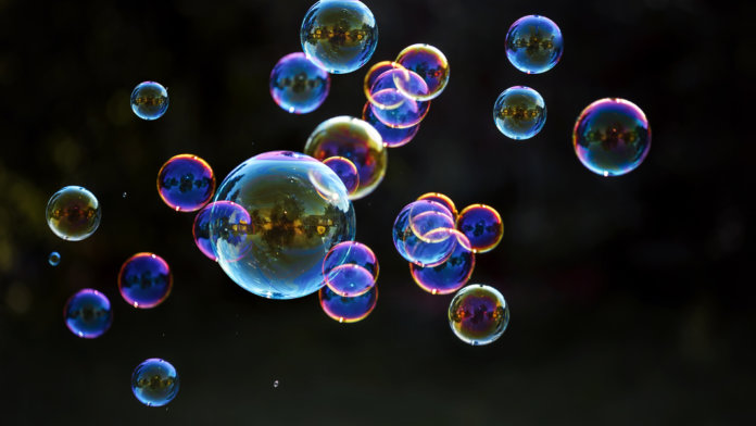 blowing bubbles in dark background