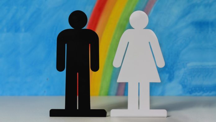 gender icons on rainbow and blue sky background