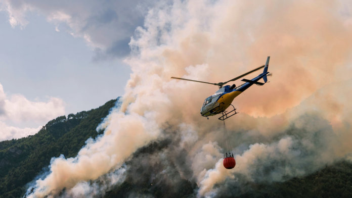 aerial firefighting with helicopter in mountains disaster relief - Convergence Peter Diamandis