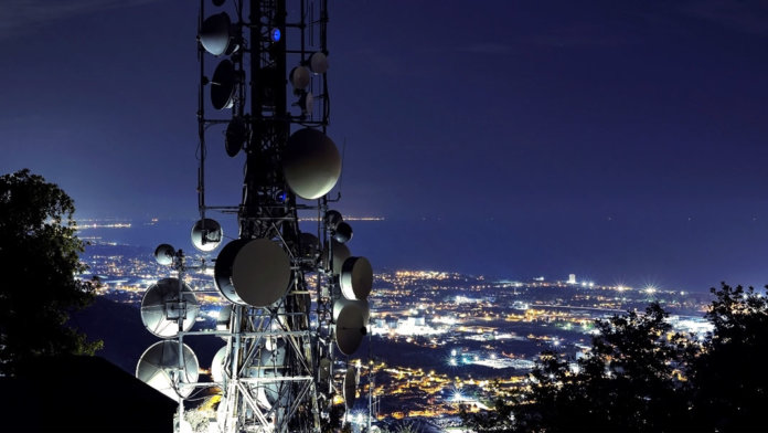 5G telecommunications tower with city view Internet of Things