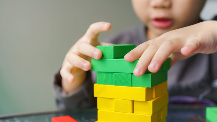 asian child playing with colorful blocks artificial intelligence