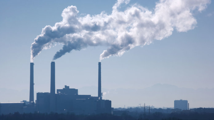 silhouette of power plant smoke stacks future of energy