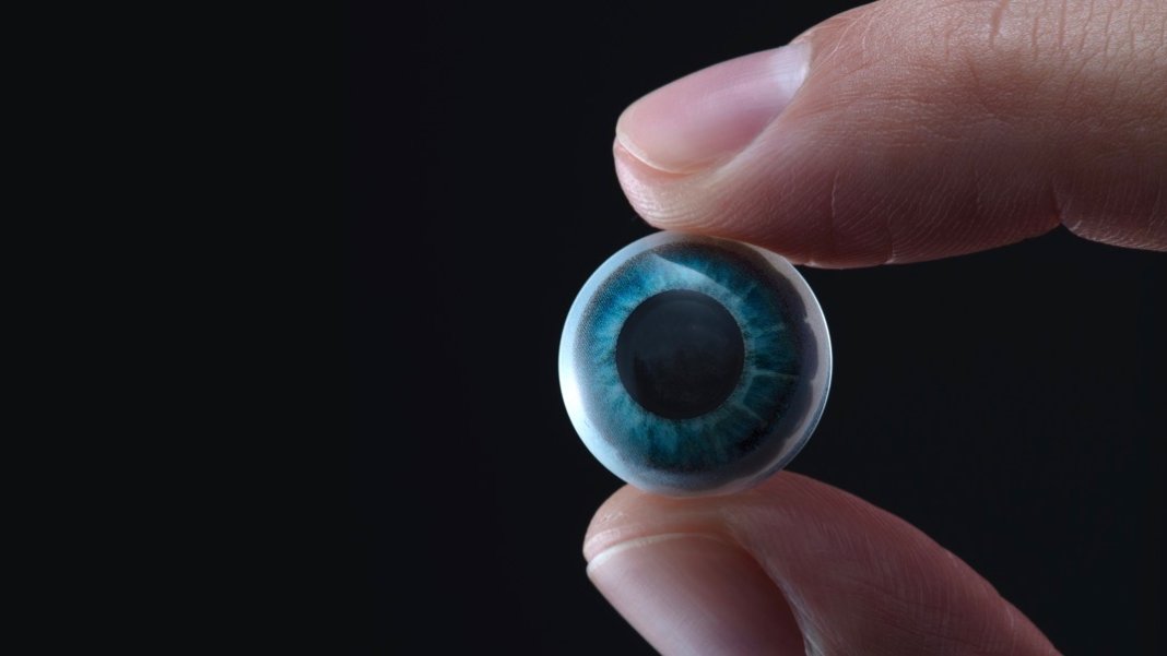 contact lens eye finger thumb black background - What will replace smartphones in 5 years