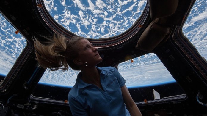 mental health mars mission karen nyberg looks through cupola on iss blue sky clouds