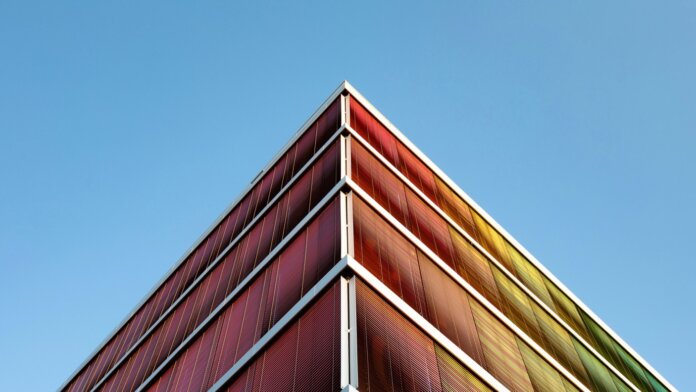tech stories building multicolored architecture blue sky