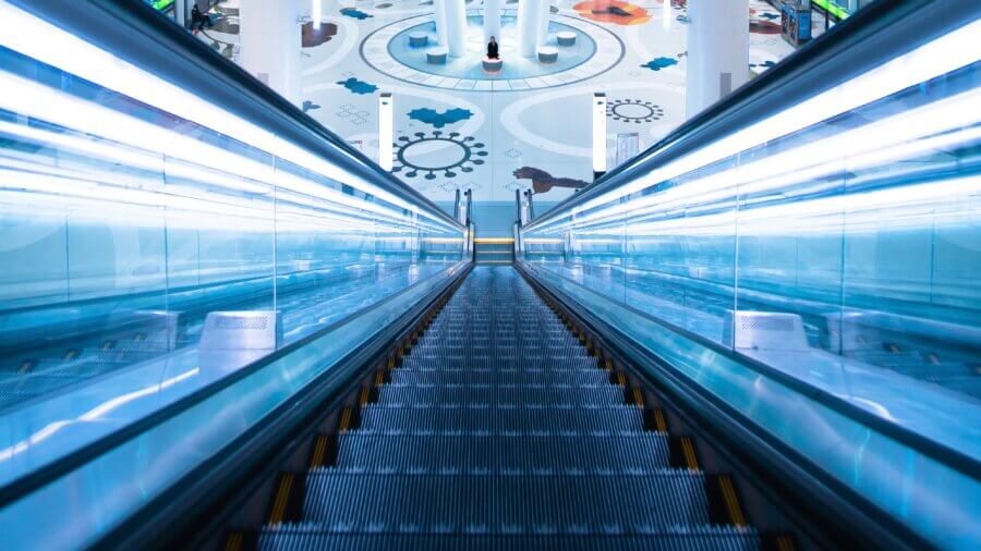 tech stories escalator vanishing point blue grey