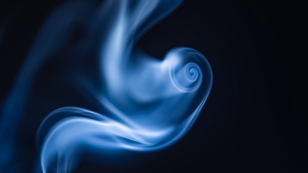 tech stories blue smoke swirl black background