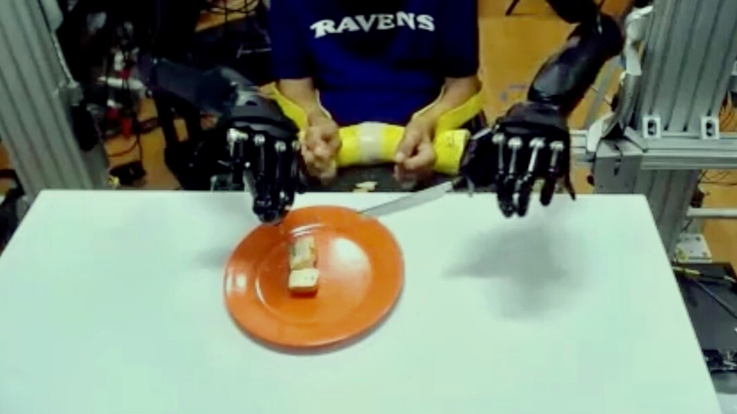 paralyzed man with robot arms eating cake fork knife