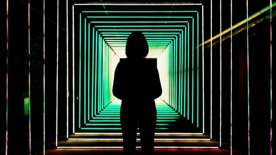 tech stories woman silhouette green led lights tunnel