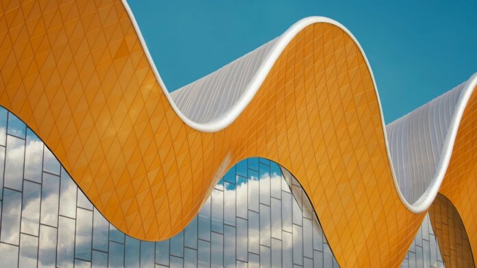 tech stories architecture wave gold blue sky mirror windows