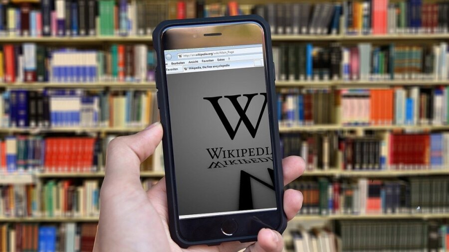 Meta Wikipedia fact checking bot books on library shelf
