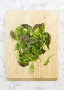 PairWise CRISPR mustard greens salad on cutting board