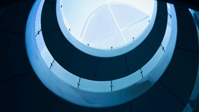 tech stories architecture building curving blue indoor balconies glass skylight