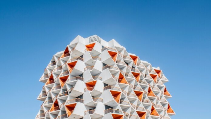 tech stories geometric architecture building orange white blue sky